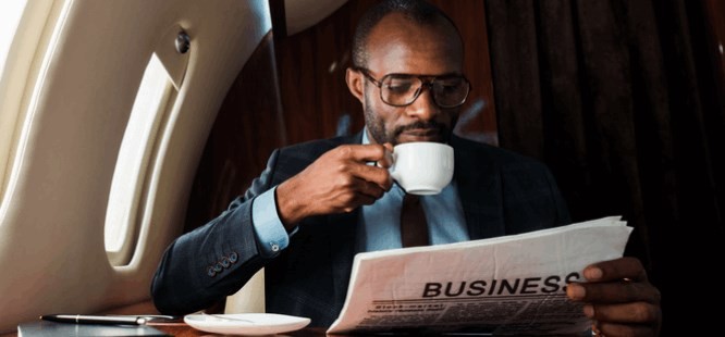 a man with a newspaper reading business page: Context: What's a business 